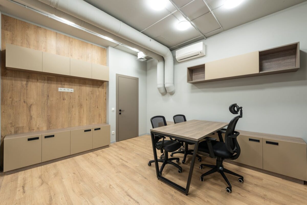 about-bg Interior of new workplace with wooden table and cabinets and black office chairs